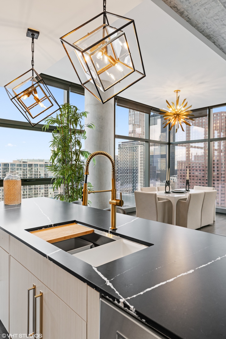 717 South Clark Street, Unit 3003 Chicago, IL 60605 - Photo 5 of 15 a kitchen with a sink and large windows