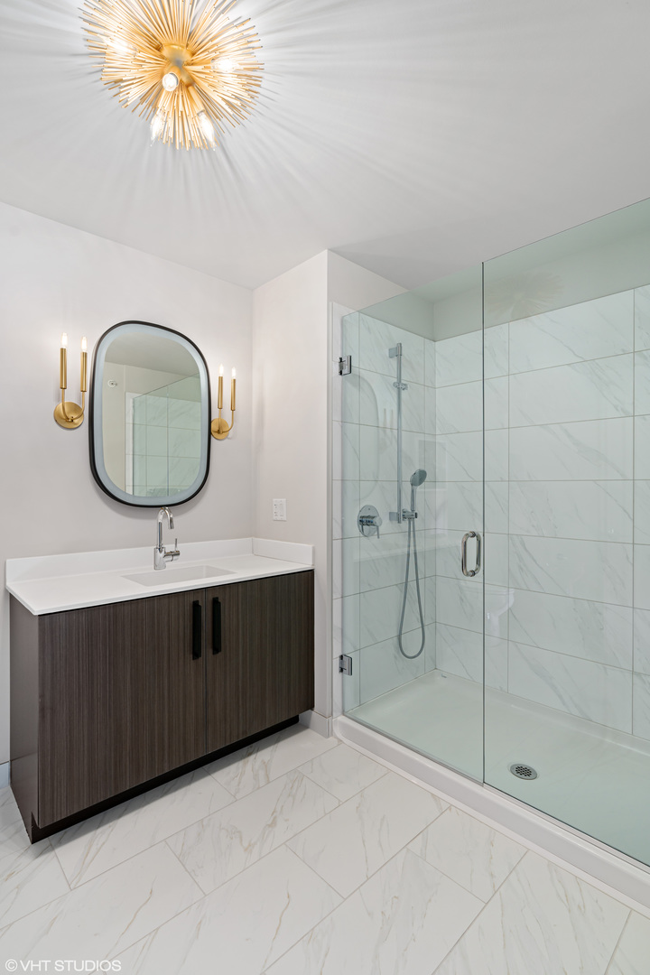 717 South Clark Street, Unit 3003 Chicago, IL 60605 - Photo 10 of 15 a bathroom with a granite countertop sink mirror and vanity