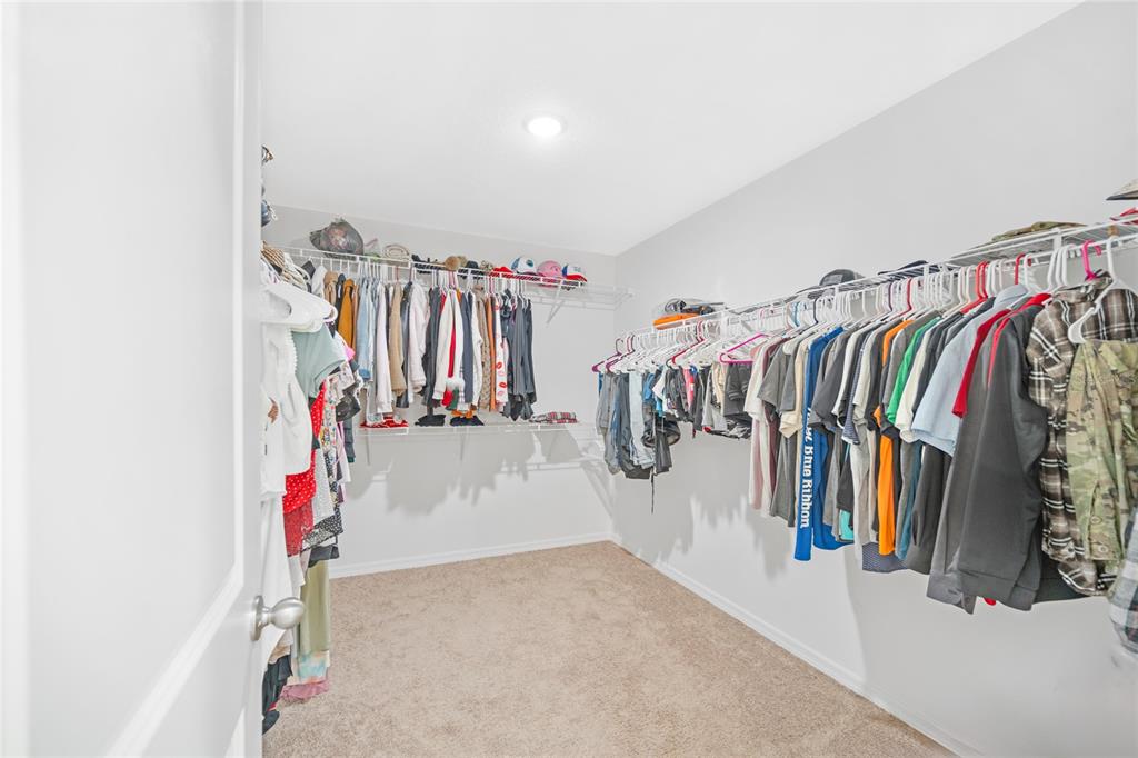 1137 Bradford Rdg Drive Leesburg, FL 34748 - Photo 20 of 37 a view of walk in closet with clothes