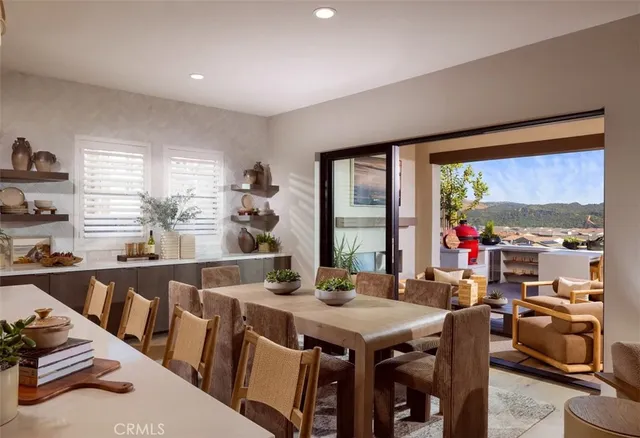 a view of a dining room and livingroom with furniture window and outside view