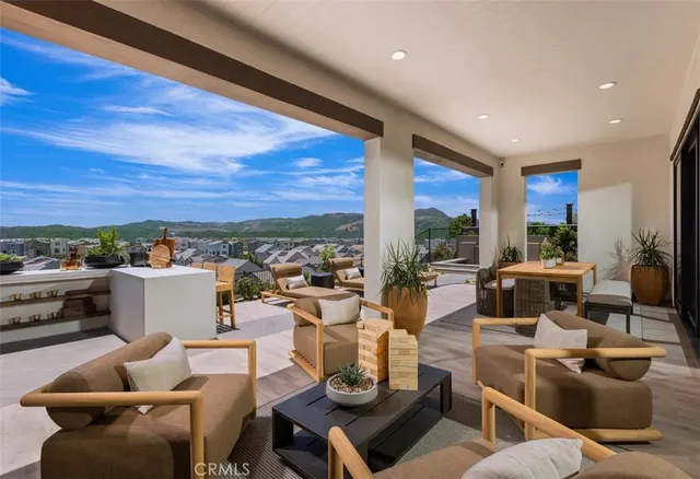 a living room with furniture and a view of kitchen