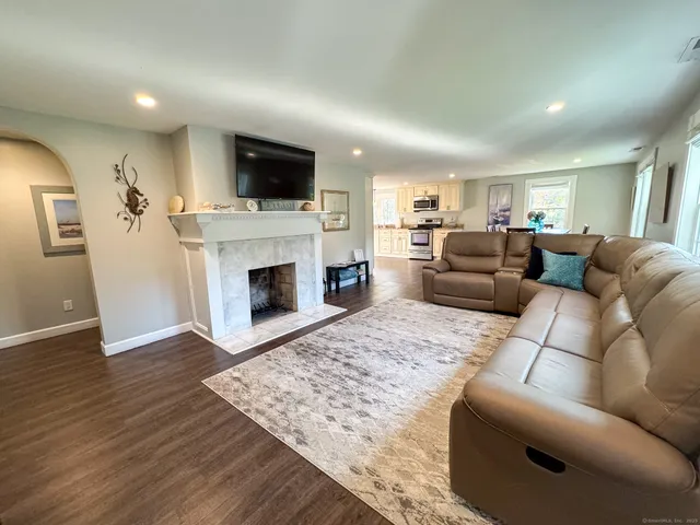 a living room with furniture flat screen tv and a fireplace