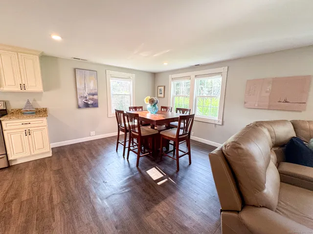 a view of a dining room with furniture window and wooden floor
