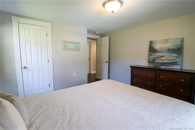 a bedroom with a bed and a dresser