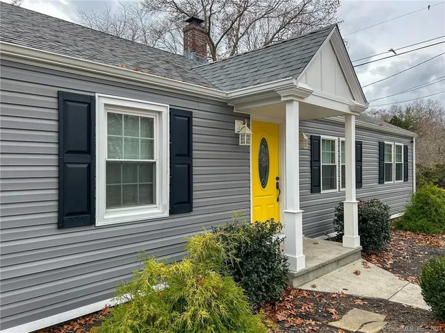 a view of a house with potted plants