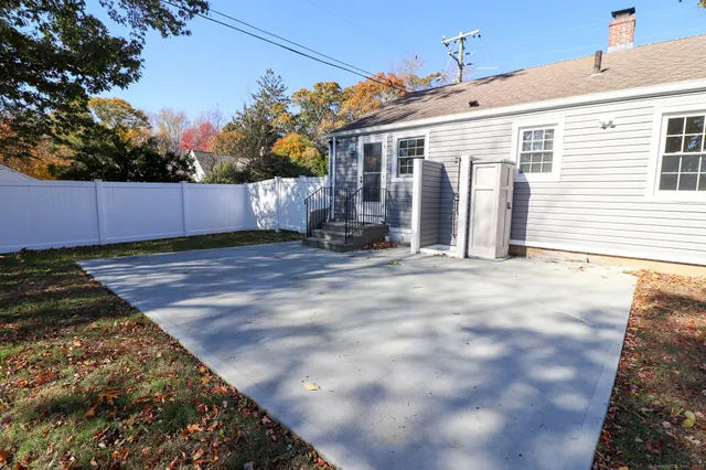 a front view of a house with yard and trees