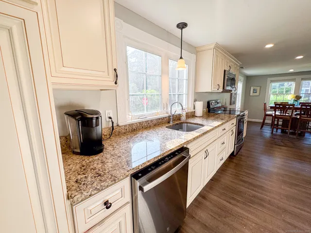 a kitchen with sink a counter top space and stainless steel appliances