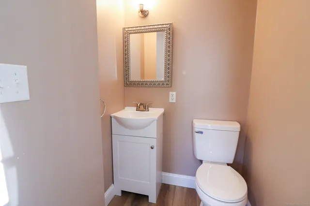 a white toilet sitting next to a bathroom sink