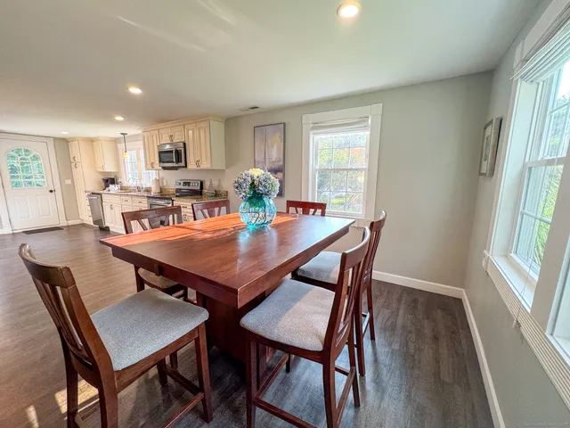 a view of a dining room with furniture and wooden floor