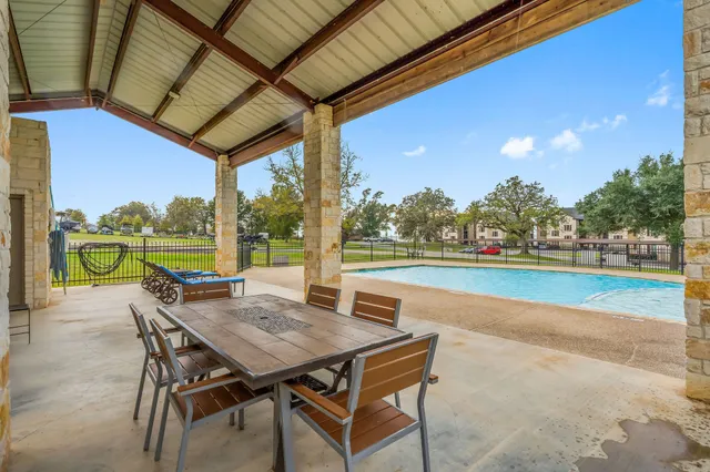 a view of a patio with a table and chairs