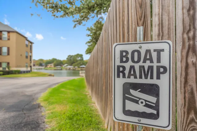 a view of a street sign under a large tree