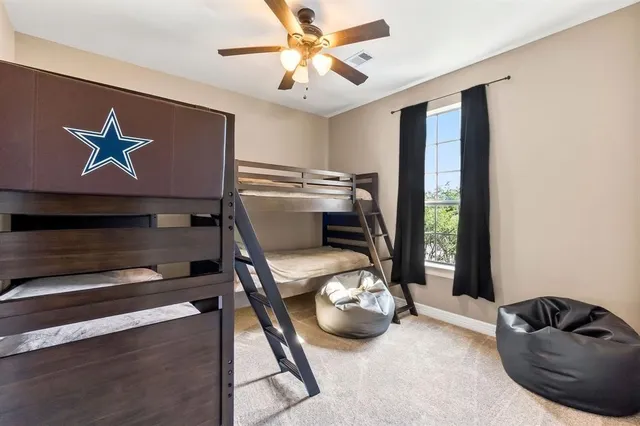 a bedroom with bed and a large window