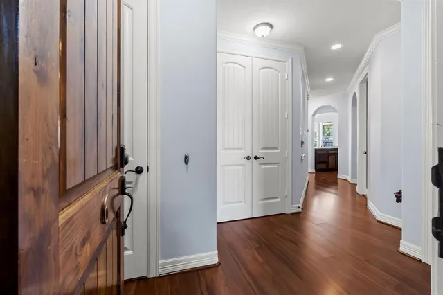 a view of a hallway with wooden floor and stairs