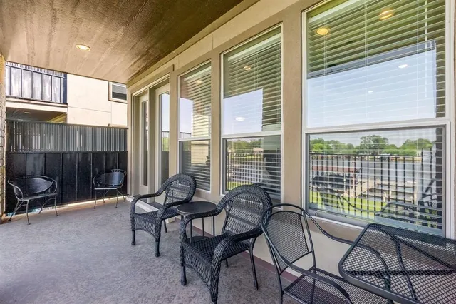 a balcony with chairs and with outdoor seating