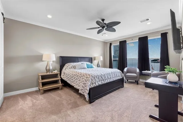 a bedroom with a bed couch and window