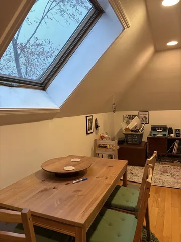 a view of a room that has a table and chairs