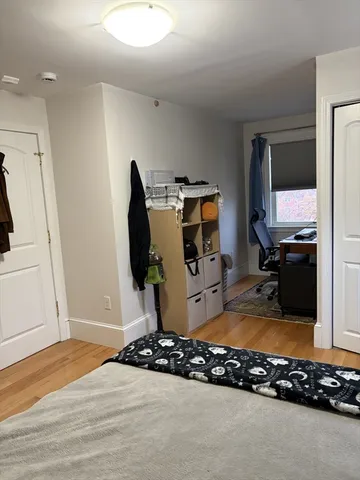 a bedroom with a bed and cabinets