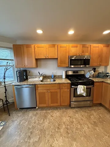 a kitchen with a stove a sink and a refrigerator