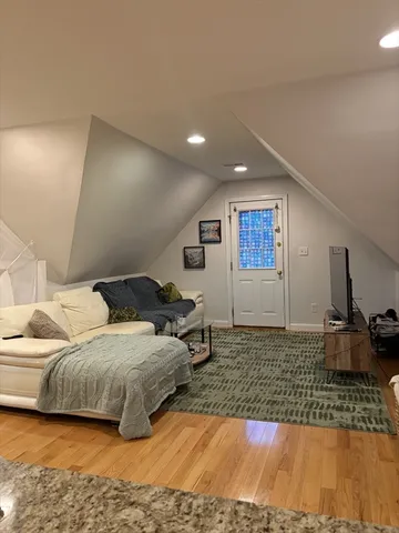 a bedroom with a large bed and a large window