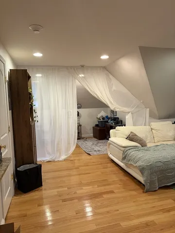 a spacious bedroom with a bed and a mirror