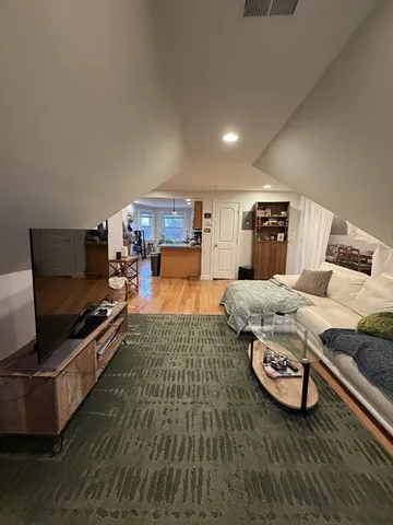 a living room with hard wood floors and a couch