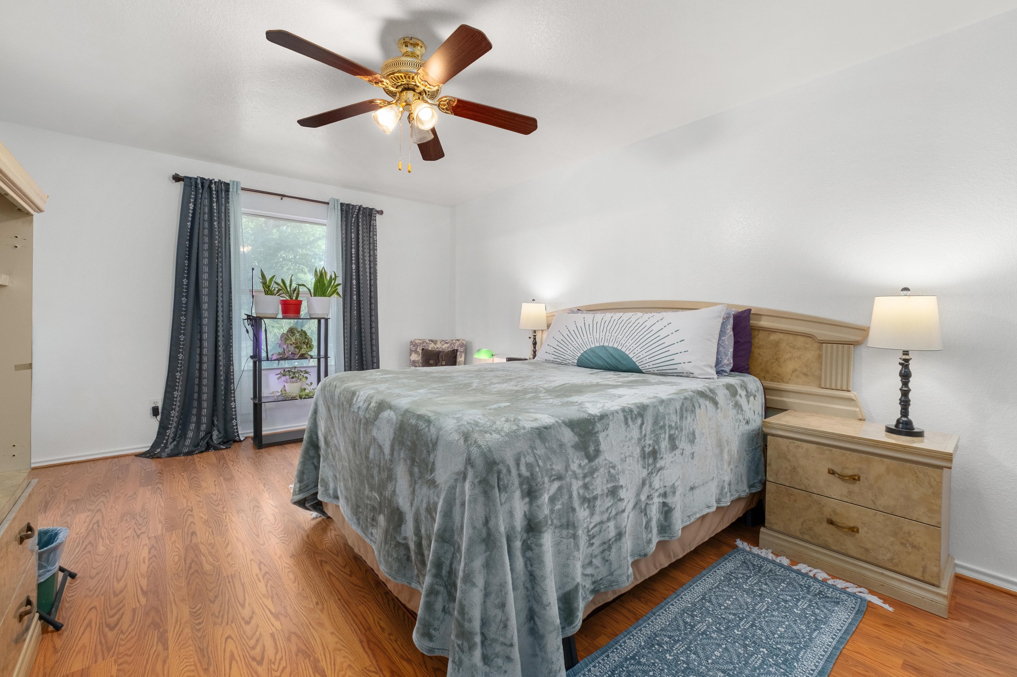 1184 Waller Street Austin, TX 78702 - Photo 8 of 19 a bedroom with a bed and a chandelier