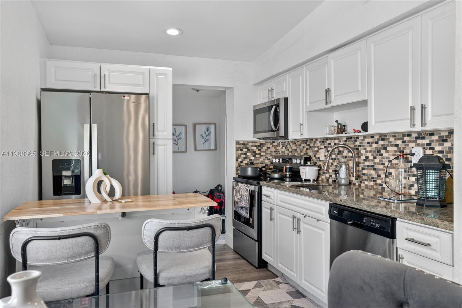 2001 Rutland Street Opa-Locka, FL 33054 - Photo 13 of 29 a kitchen with stainless steel appliances granite countertop a sink and cabinets