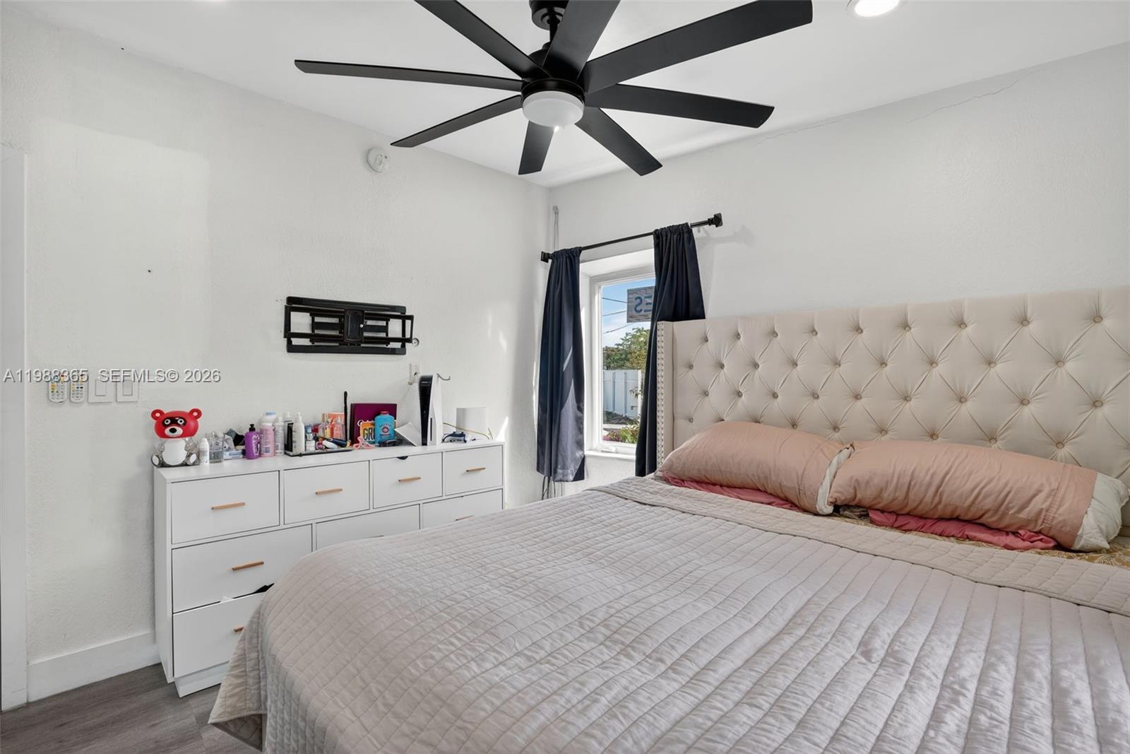 2001 Rutland Street Opa-Locka, FL 33054 - Photo 17 of 29 a bedroom with a bed chandelier and a window