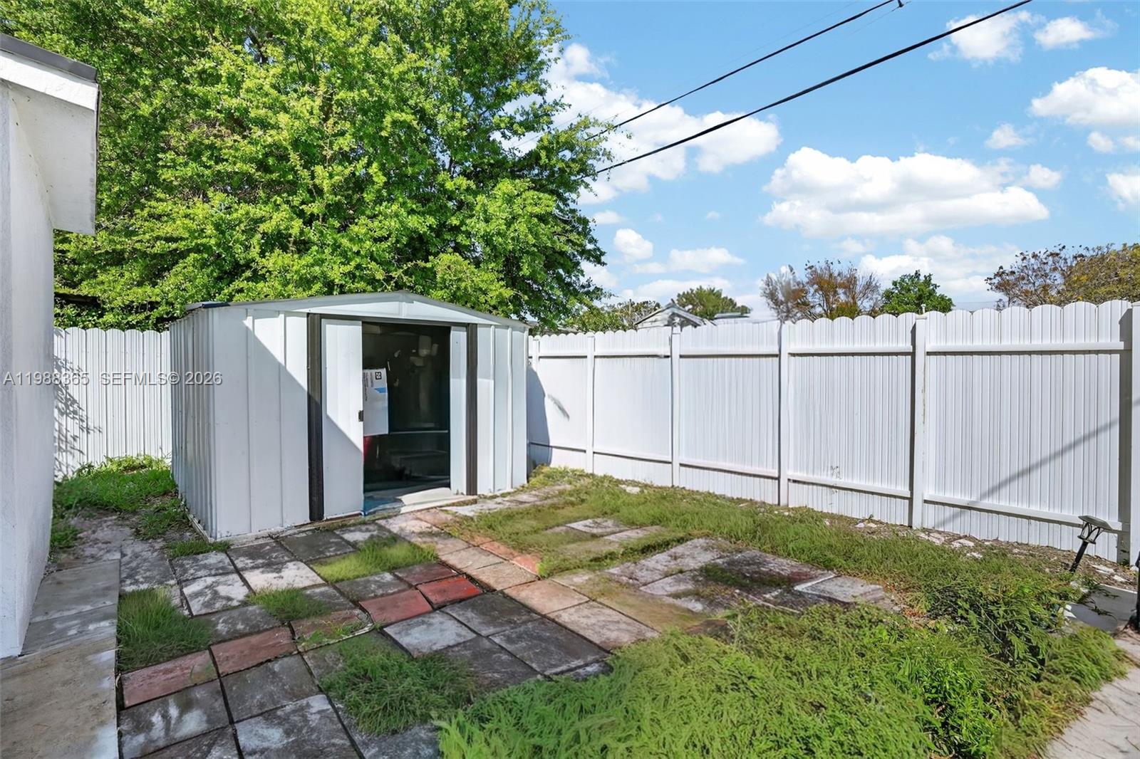 2001 Rutland Street Opa-Locka, FL 33054 - Photo 24 of 29 a view of a backyard with plants and a large tree