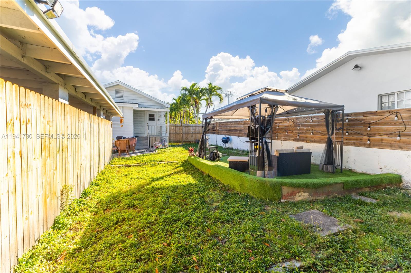 2811 Southwest 17th Street Miami, FL 33145 - Photo 29 of 36 a view of a house with a yard porch and furniture
