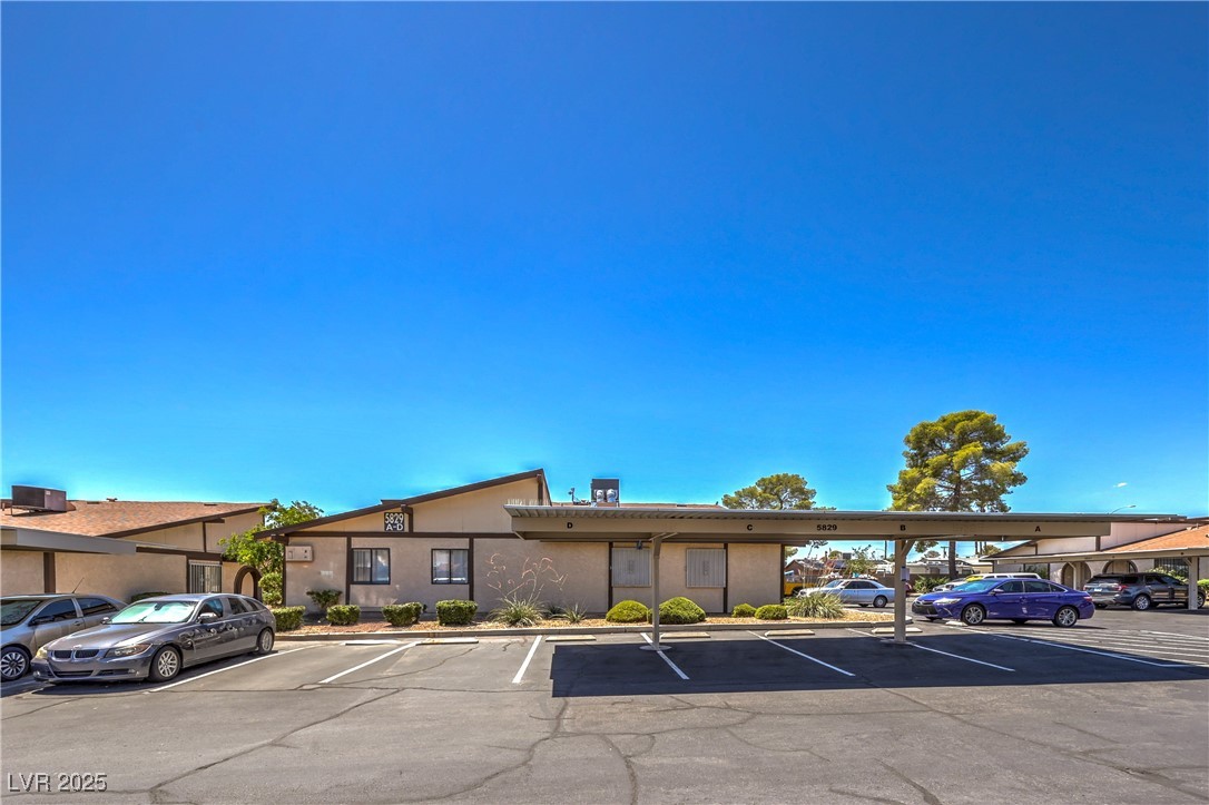 5829 Smoke Ranch Road, Unit C Las Vegas, NV 89108 - Photo 1 of 25 View of building exterior featuring covered and un