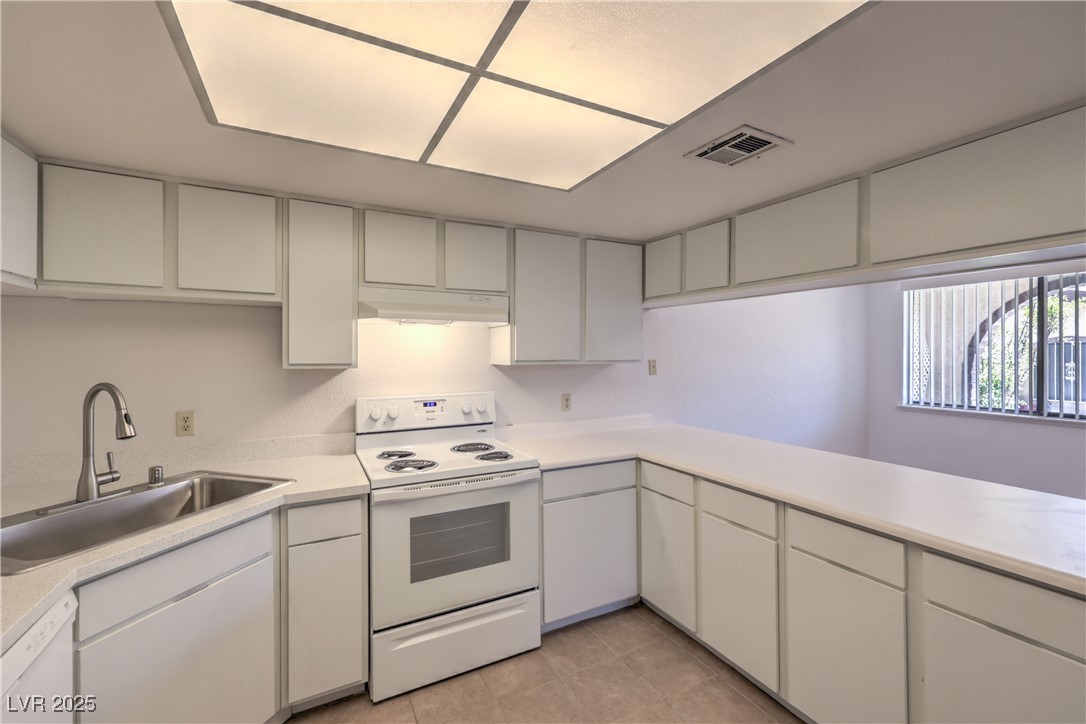 5829 Smoke Ranch Road, Unit C Las Vegas, NV 89108 - Photo 11 of 25 Kitchen with white appliances, light countertops,