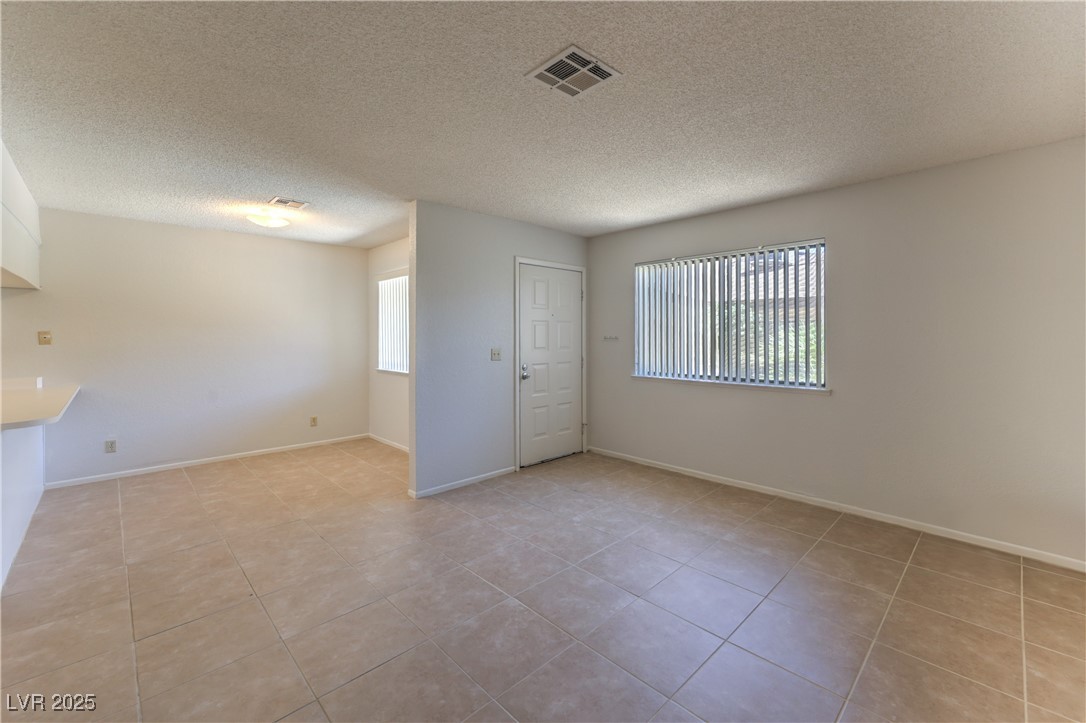 5829 Smoke Ranch Road, Unit C Las Vegas, NV 89108 - Photo 13 of 25 Empty room with light tile patterned flooring and