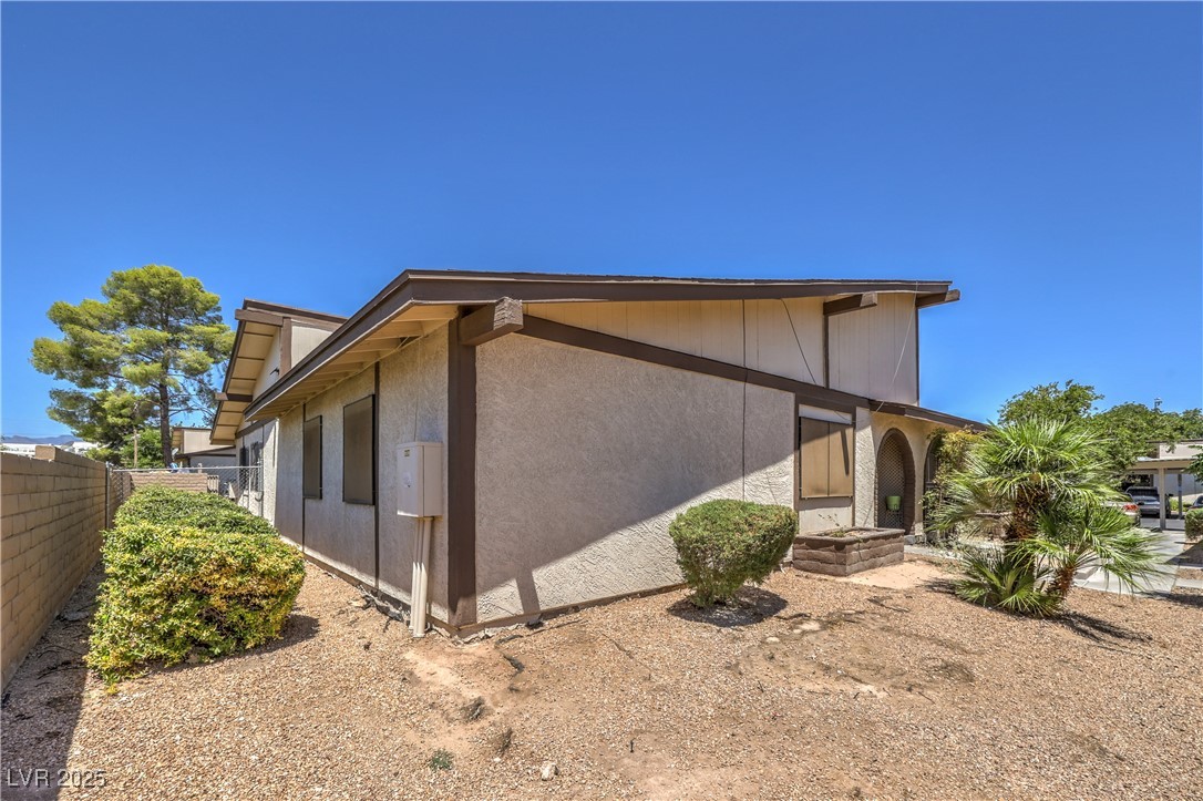 5829 Smoke Ranch Road, Unit C Las Vegas, NV 89108 - Photo 24 of 25 View of home's exterior featuring stucco siding