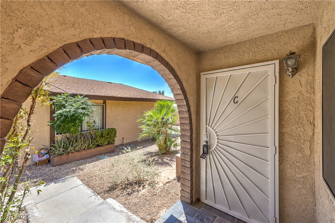 5829 Smoke Ranch Road, Unit C Las Vegas, NV 89108 - Photo 25 of 25 Doorway to property with stucco siding