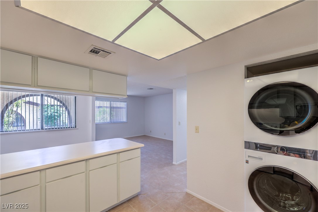 5829 Smoke Ranch Road, Unit C Las Vegas, NV 89108 - Photo 3 of 25 Laundry area with stacked washer and clothes dryer