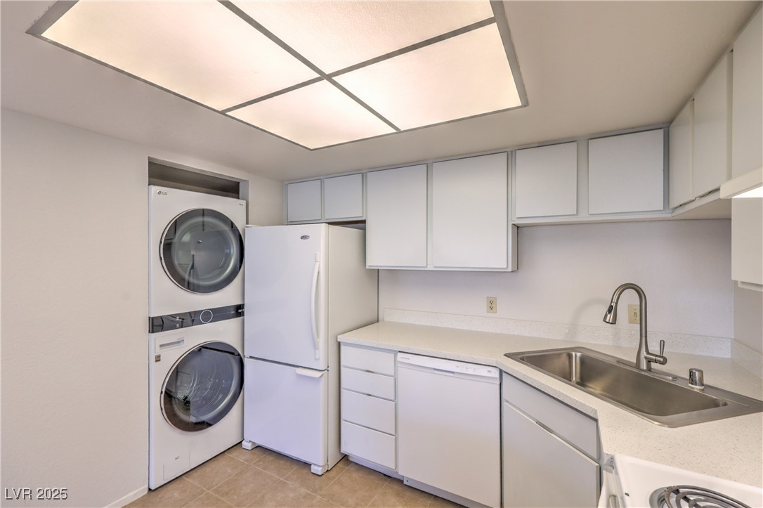5829 Smoke Ranch Road, Unit C Las Vegas, NV 89108 - Photo 8 of 25 Kitchen featuring stacked washer / drying machine,