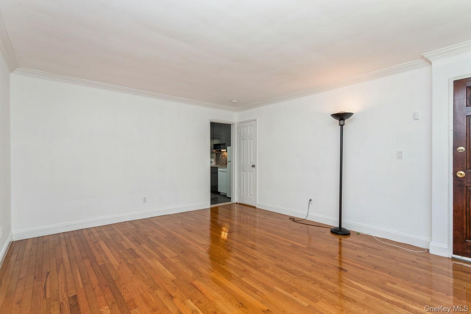 51 Cross Street, Unit 3A Yonkers, NY 10708 - Photo 4 of 17 Unfurnished room with wood finished floors and crown molding