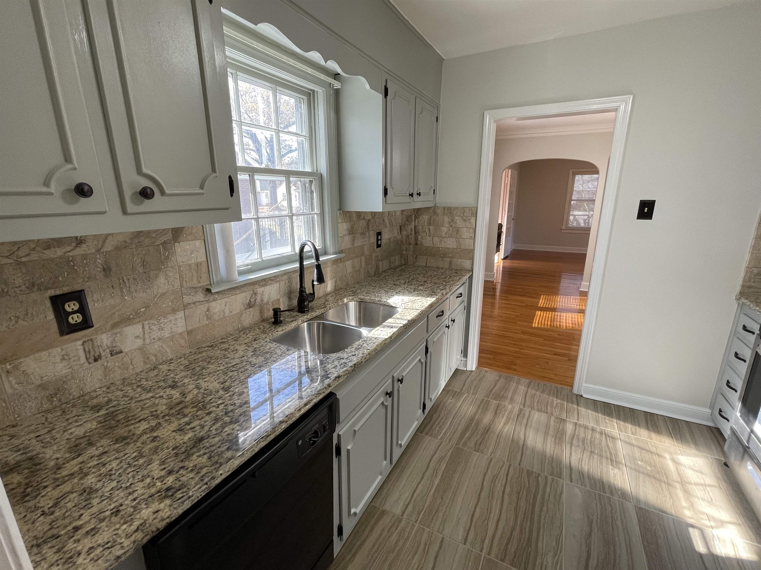 1020 Sandra Street Memphis, TN 38122 - Photo 11 of 40 a kitchen with granite countertop a sink stove and cabinets