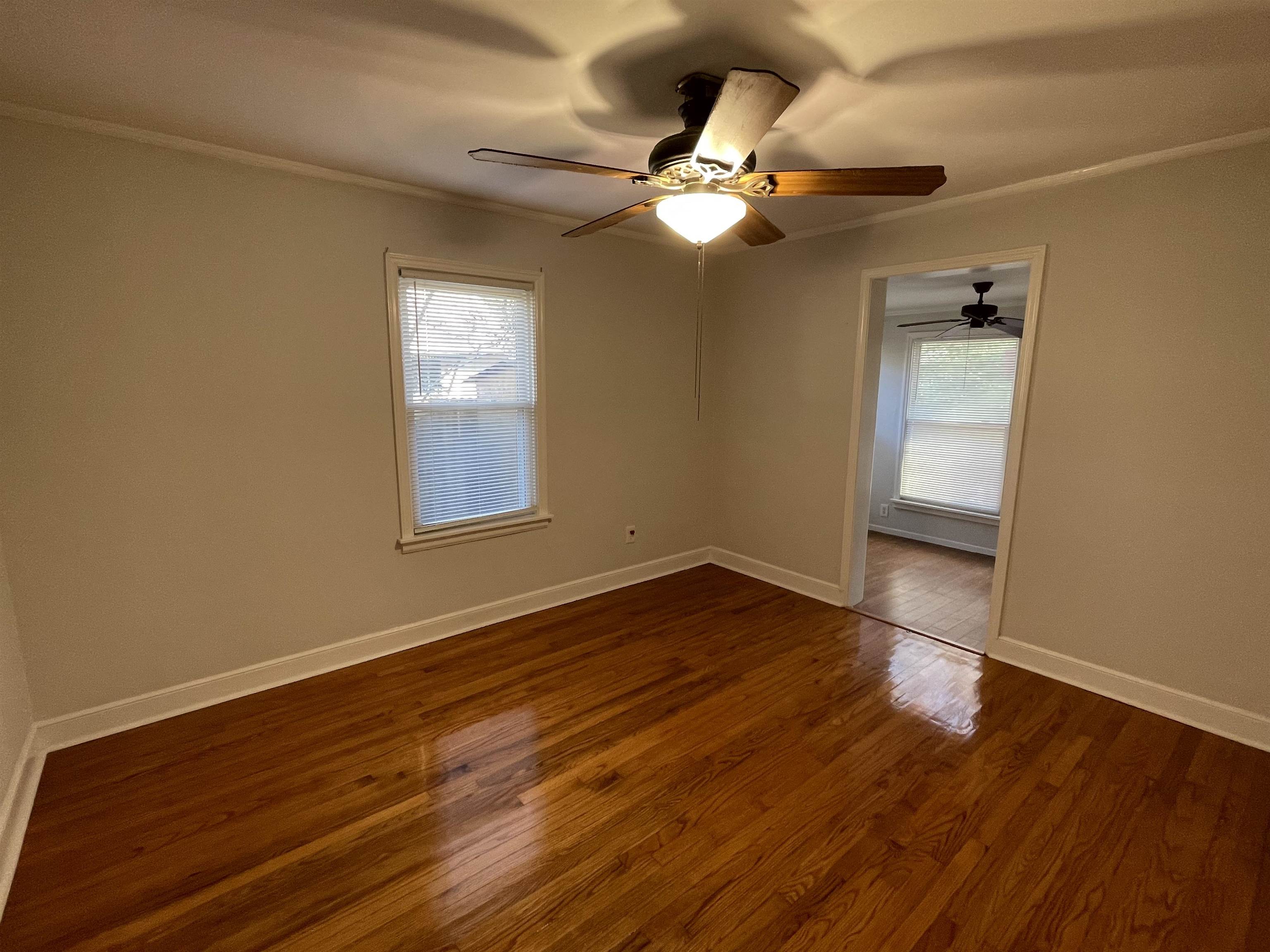 1020 Sandra Street Memphis, TN 38122 - Photo 15 of 40 a view of an empty room with wooden floor and a window