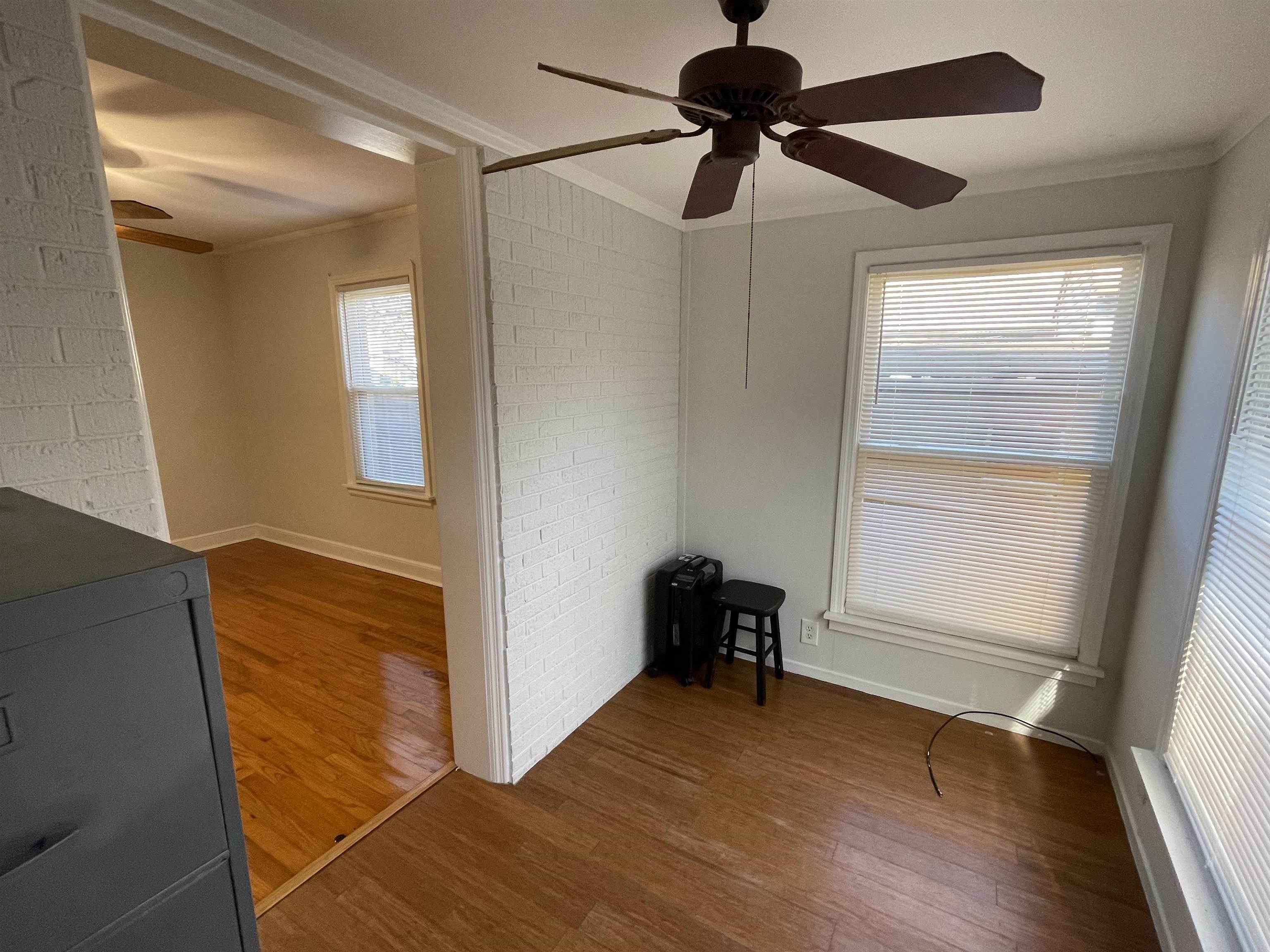 1020 Sandra Street Memphis, TN 38122 - Photo 16 of 40 a view of an empty room with a window and wooden floor