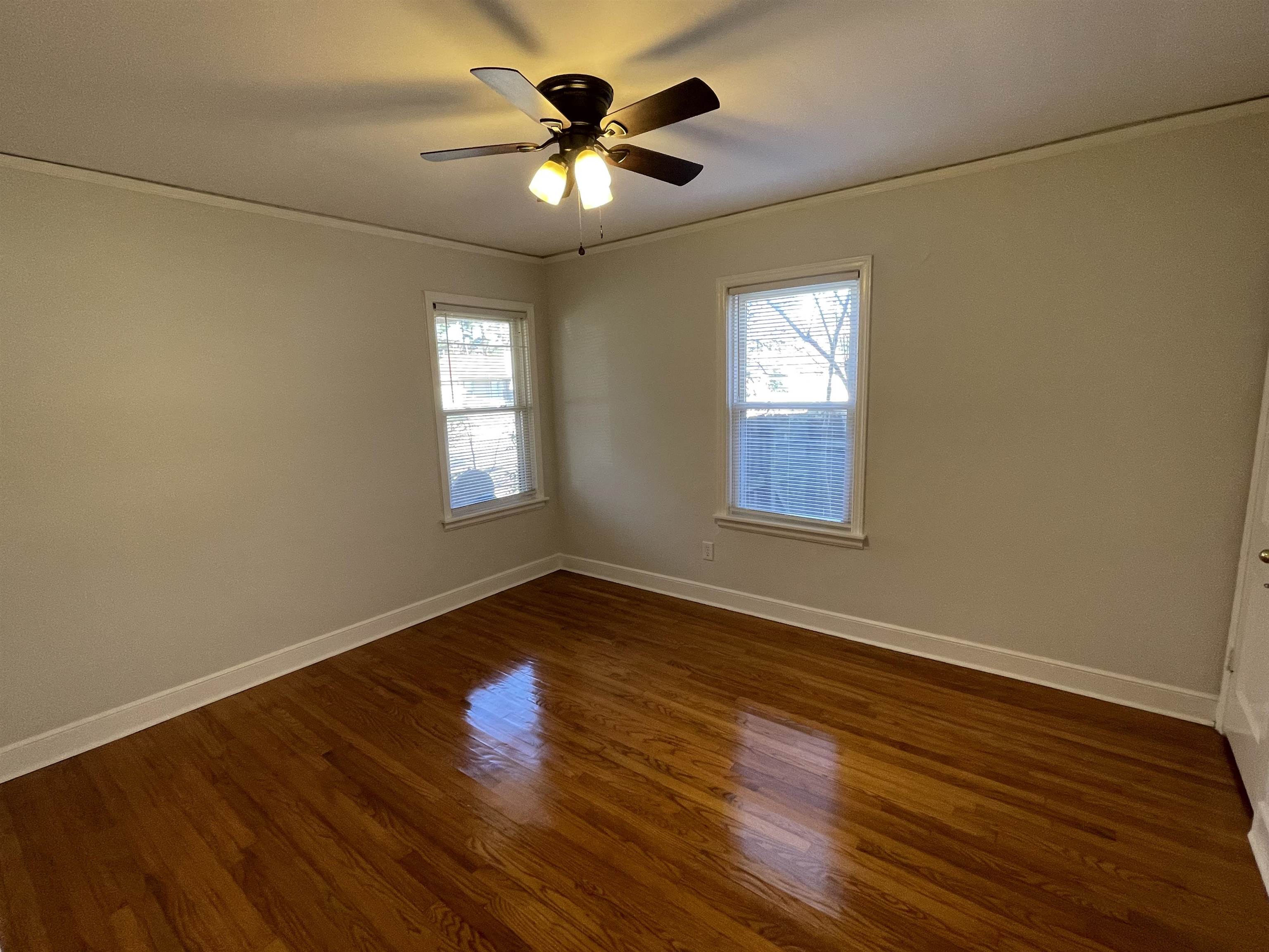 1020 Sandra Street Memphis, TN 38122 - Photo 18 of 40 an empty room with wooden floor and windows