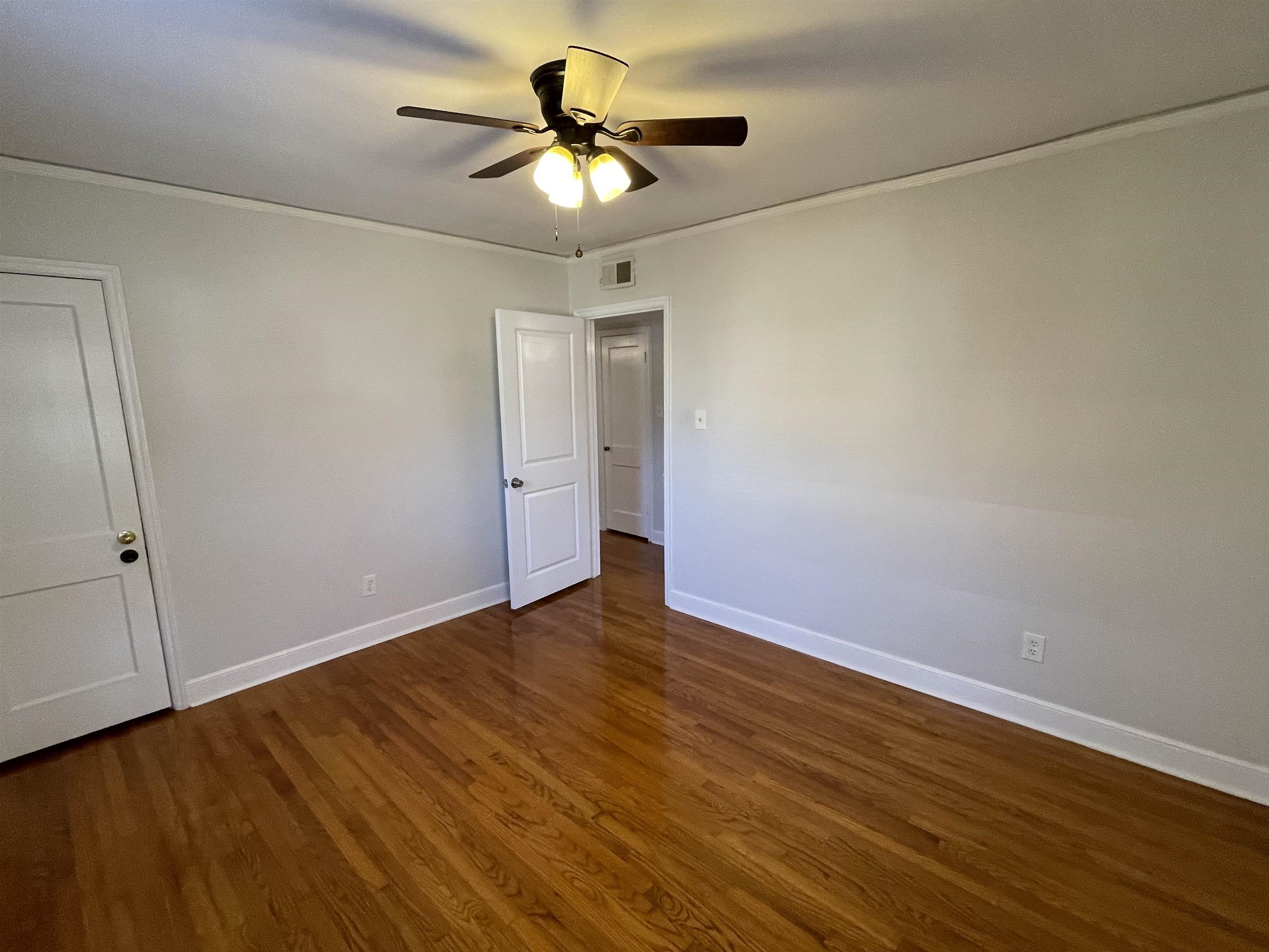 1020 Sandra Street Memphis, TN 38122 - Photo 19 of 40 an empty room with wooden floor and windows