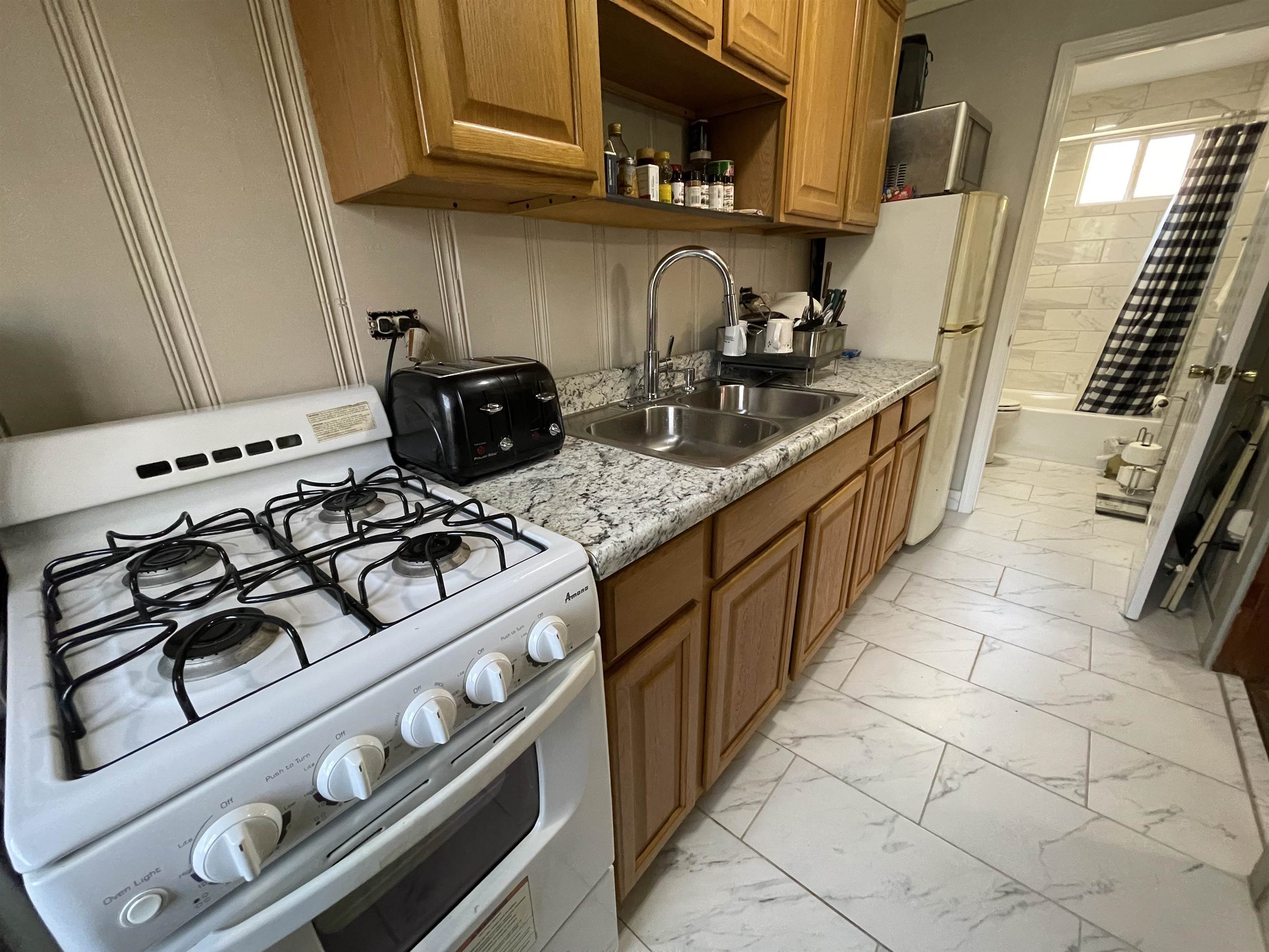 1020 Sandra Street Memphis, TN 38122 - Photo 38 of 40 a kitchen with a stove and a sink