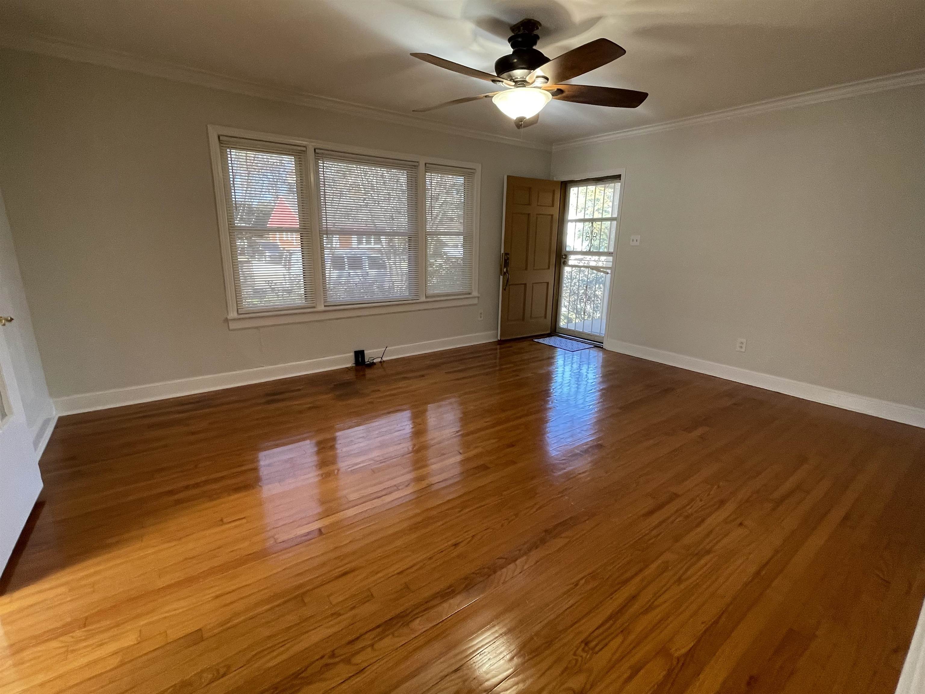 1020 Sandra Street Memphis, TN 38122 - Photo 6 of 40 a view of empty room with wooden floor and fan