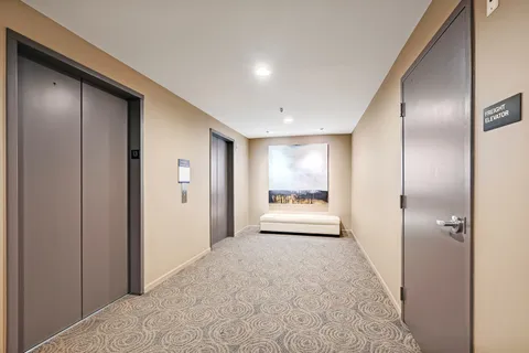 a view of a big room with wooden floor and a bathroom