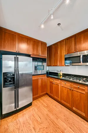 a kitchen with stainless steel appliances granite countertop a refrigerator a sink and dishwasher