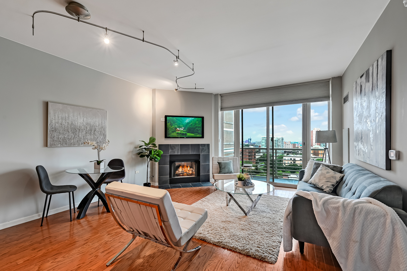 1515 South Prairie Avenue, Unit 1318 Chicago, IL 60605 - Photo 9 of 31 a living room with fireplace furniture and a floor to ceiling window
