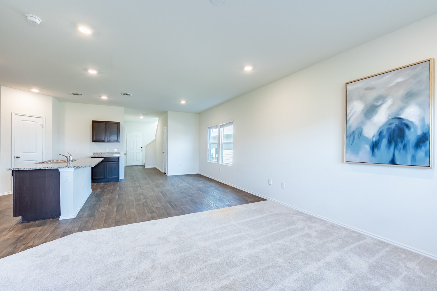 14917 Bajada Rd Manor Manor, TX 78653 - Photo 6 of 31 Open-concept living space featuring wood-finish flooring, recessed lighting, and light-toned carpeting