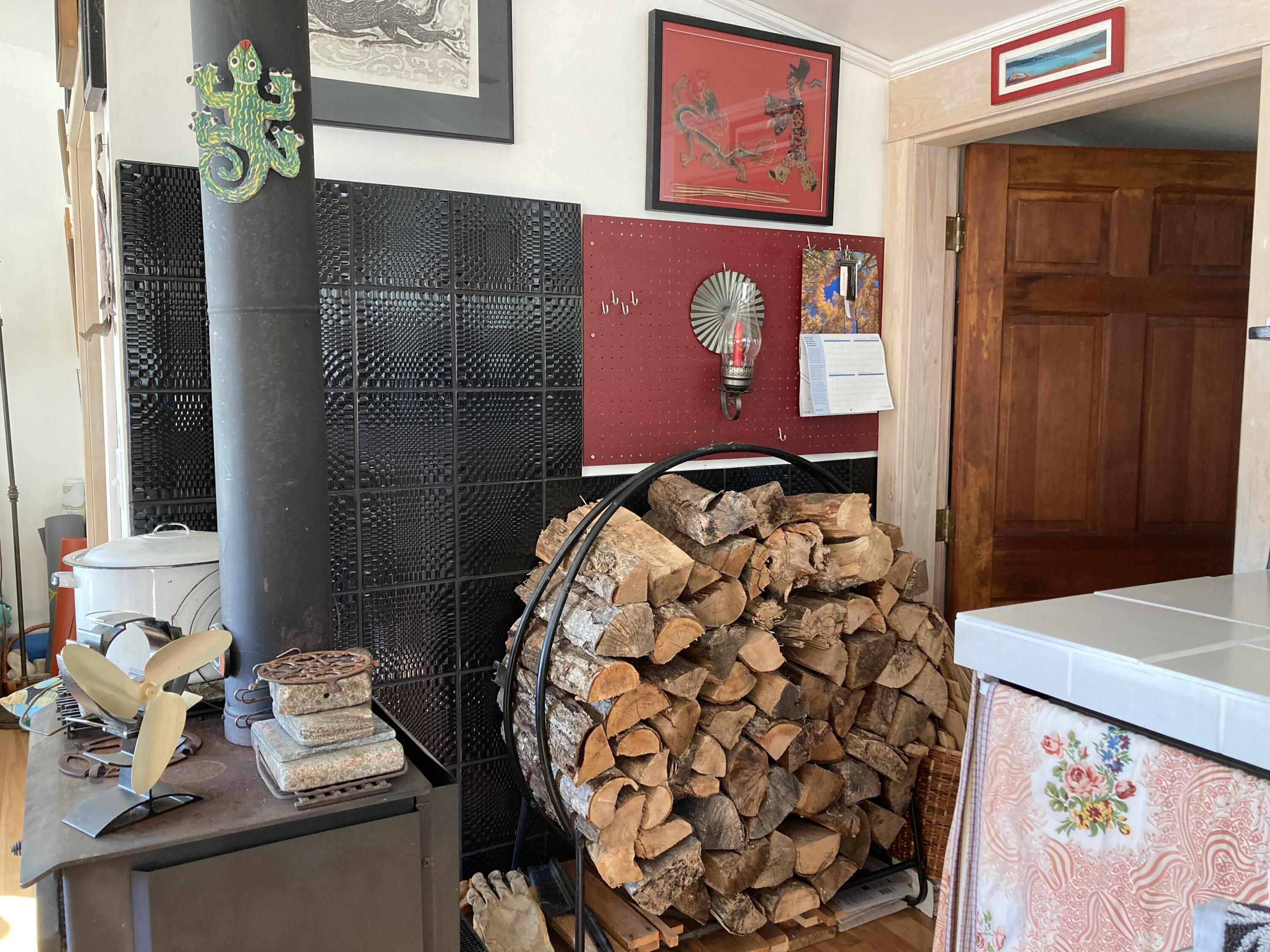 349 Oceanville Road Stonington, ME 04681 - Photo 12 of 16 Woodstove and wood storage.